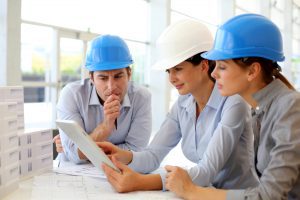 Architects working in office on construction project